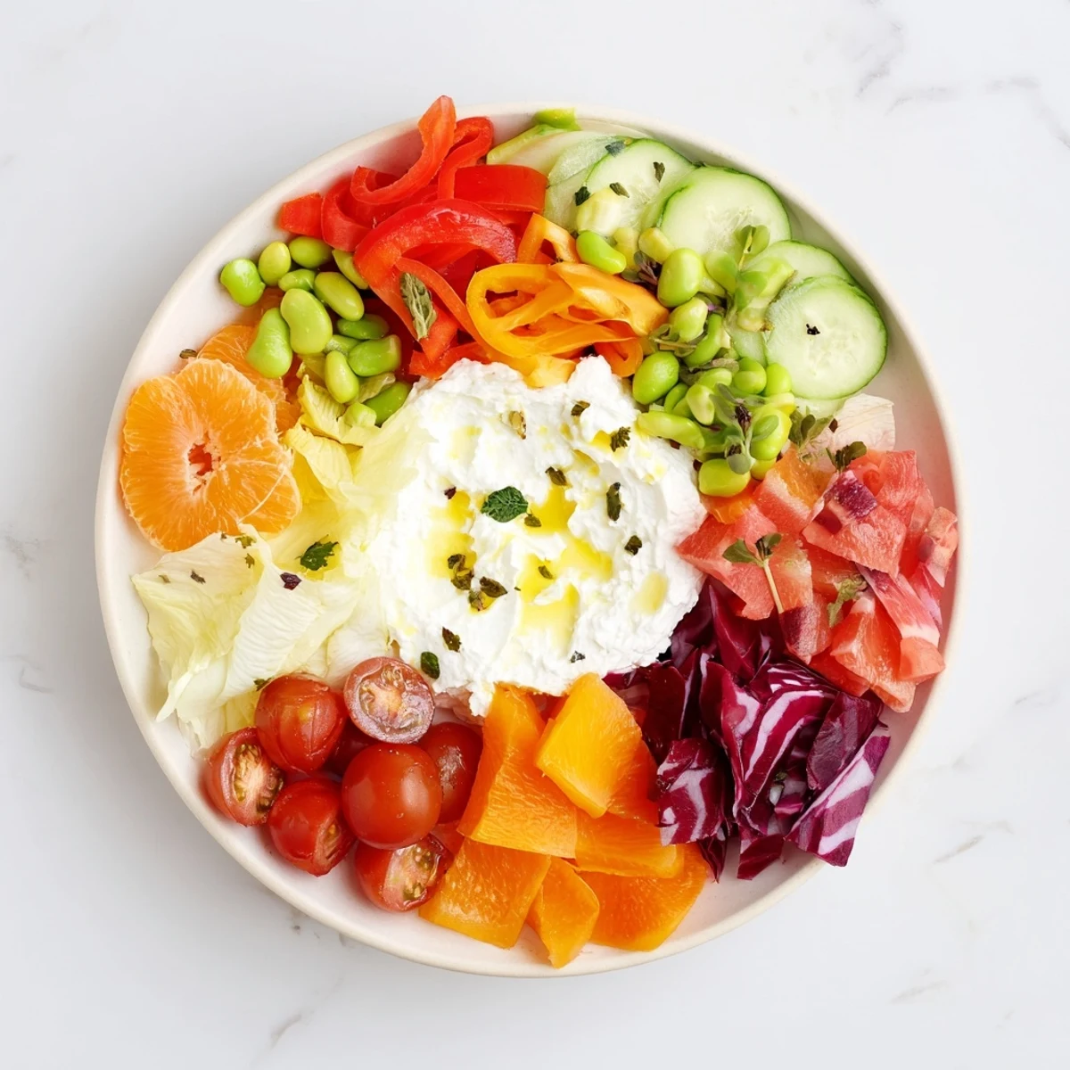 The Prism Burst salad showcases colorful layers of fresh fruits and vegetables on a white base.