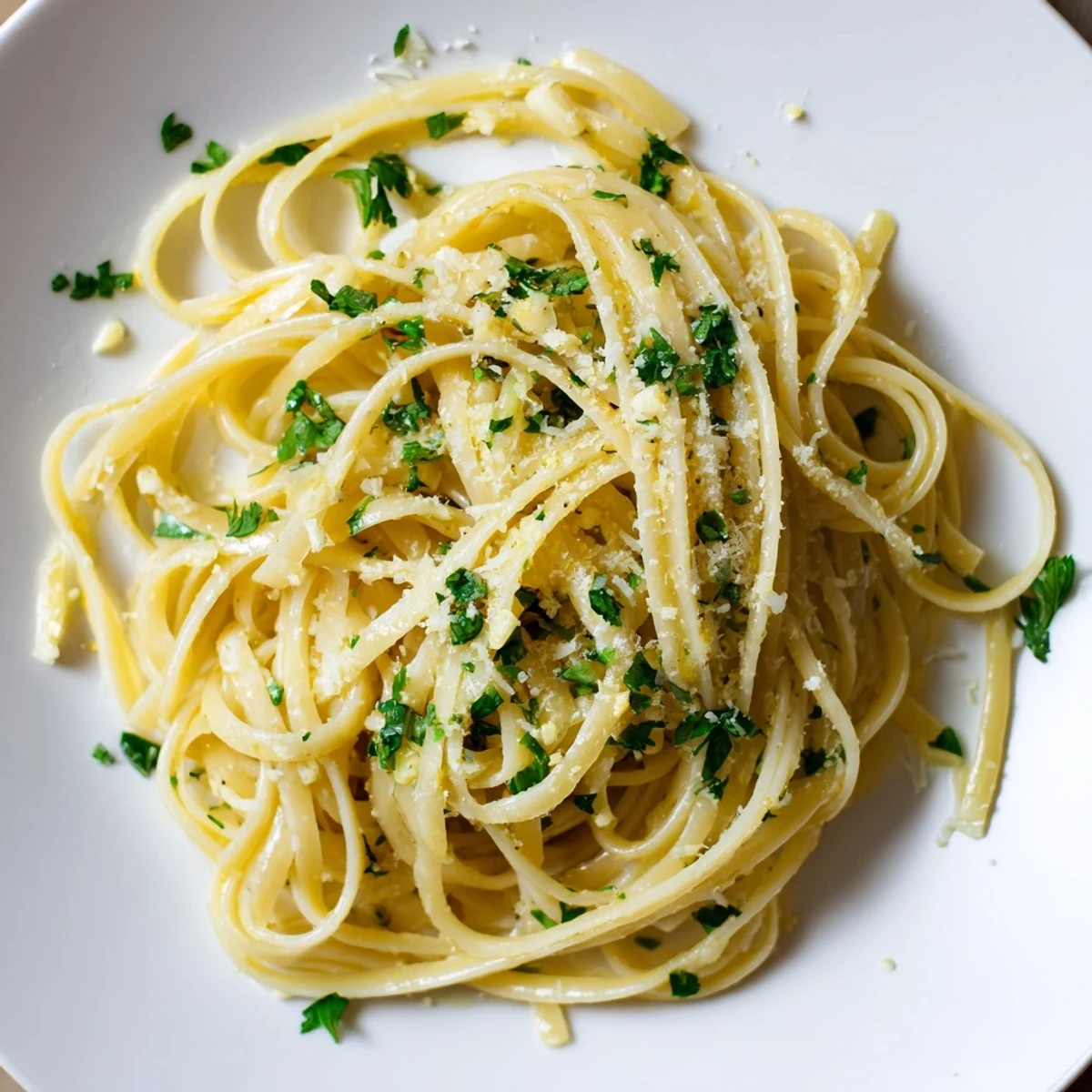 Steaming Garlic Butter Linguine, tossed with fresh parsley and ready for a delicious dinner.