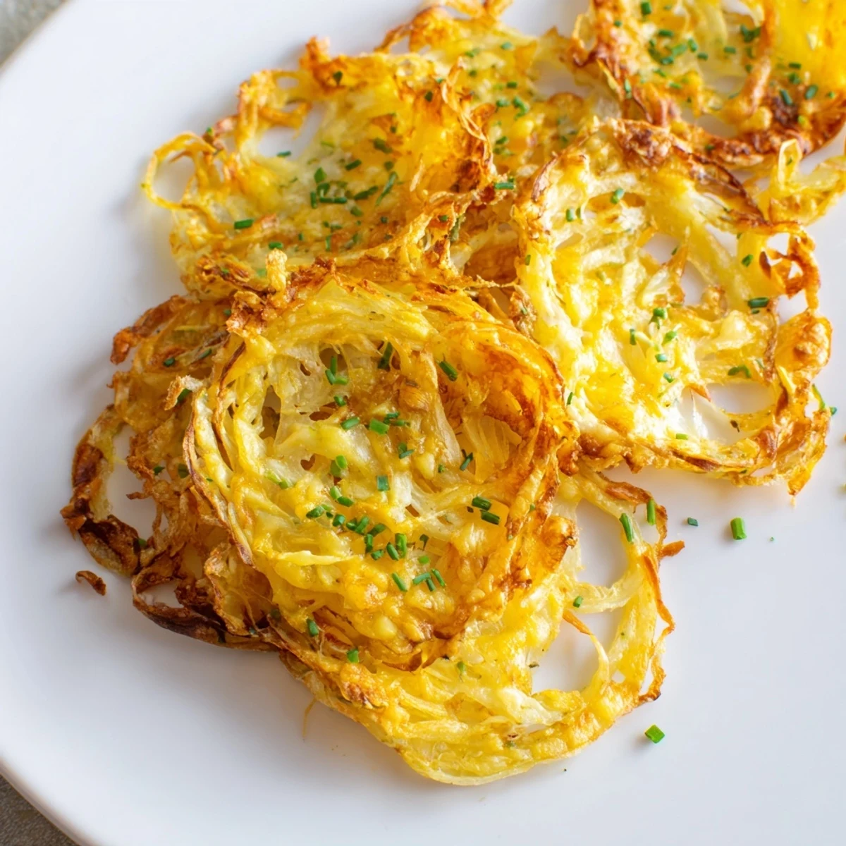 Melted cheese bubbles over thinly sliced onions in these irresistible crispy onion cheese chips.