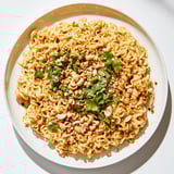 A close-up view of a bowl of Instant Peanut Thai Sauce Noodles, garnished with fresh cilantro and peanuts.