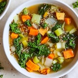 Bright oranges and greens highlight this flavorful Nourishing Winter Veggie Soup, perfect for a cold evening.