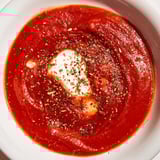 This Instant Creamy Marinara Hack features a vibrant, red sauce that coats a wooden spoon beautifully.