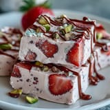 Creamy Greek yogurt bark with sliced strawberries and chopped pistachios, perfect for sharing on Valentine's Day.  