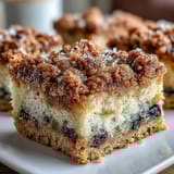 Moist sourdough coffee cake squares bursting with fresh blueberries, bright lemon flavor, and a buttery streusel topping.