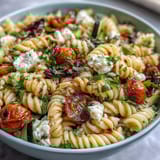 Colorful pasta salad featuring cherry tomatoes, bell peppers, and olives, all coated in a tangy homemade Italian dressing.