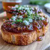 Bright golden dandelion jelly with delicate floral notes, perfect for spreading on warm buttered toast or fresh scones.