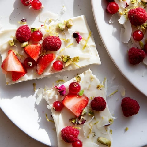 Sweet and cool frozen yogurt bark with vibrant red berries, ready for a delicious treat.