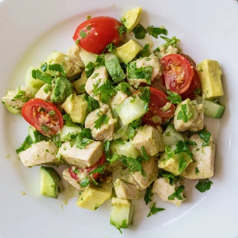 Freshly made Avocado Chicken Salad with diced chicken, creamy avocado chunks, juicy cherry tomatoes, and crisp cucumber tossed in a zesty lime dressing.  