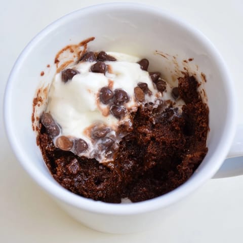 A close-up of a perfectly cooked chocolate mug cake, a delightful American dessert.