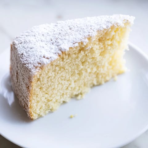 Fluffy, golden-brown slices of Simple 3-Ingredient Vanilla Sponge Cake, perfect for dessert.