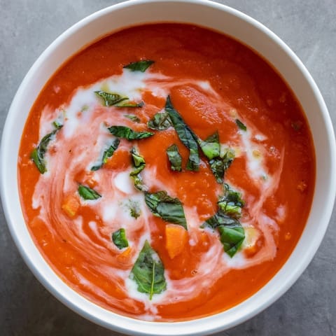 Rich and creamy tomato and basil soup, made with fresh basil and ripe tomatoes for the best flavor.