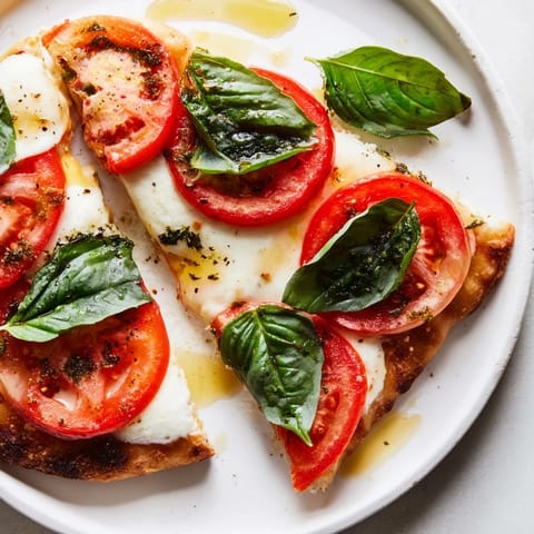 Golden-crusted Quick Margherita Naan Pizza straight from the oven, offering a delightful flatbread meal.