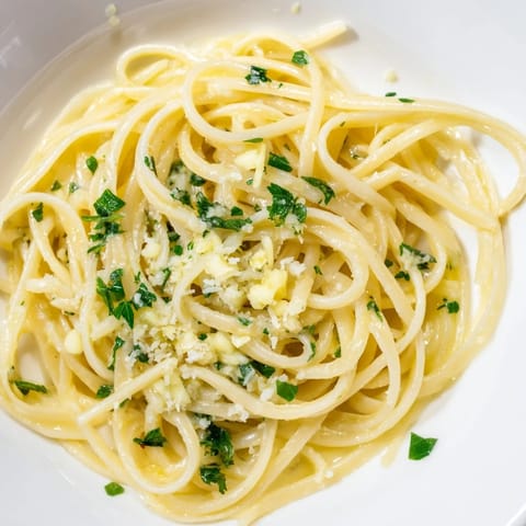 Golden-hued Garlic Butter Linguine with bright green parsley, a simple yet satisfying Italian meal.