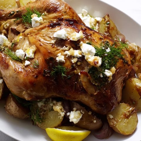 Roasted Chicken with Pot Potatoes, Lemon Herbs, and Feta bubbling in a cast-iron skillet, showcasing crispy skin and herbaceous aromatics.