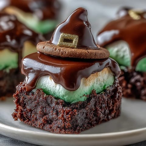 Festive Leprechaun Hat Brownie Bites with chocolate-dipped marshmallows and green icing for St. Patrick's Day.  