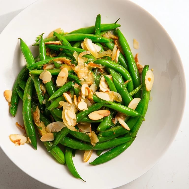 A close-up of Sautéed Green Beans with Garlic and Almonds, showcasing the flavorful dish's vibrant colors.