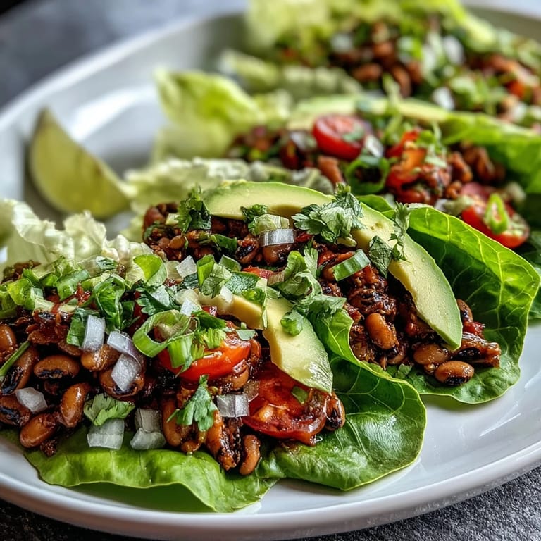 Delicious vegetarian Black-Eyed Pea Lettuce Wraps garnished with cilantro and green onions, ready to eat for a healthy lunch.