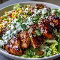 Healthy Chicken and Street Corn Bowls with juicy grilled chicken, smoky-sweet corn, and crisp vegetables, topped with tangy Greek yogurt dressing for a vibrant, high-protein meal.